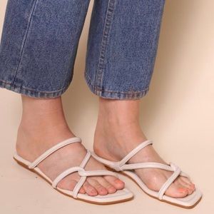 Intentionally blank white Kinney cream sandals